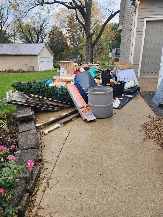 Dumpster being loaded with debris for Estate Cleanout Dumpster Rental in West Burlington